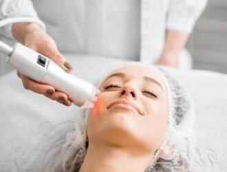 Young woman during a facial massage with professional tool at the medical center